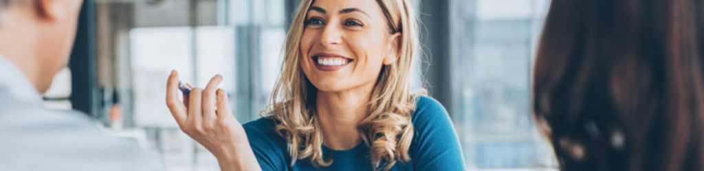 Lady holding pen in meeting at office